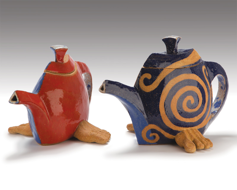 narrow teapots with partial human feet on either side at the base