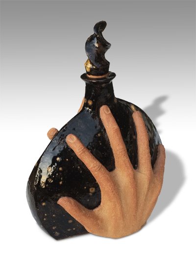 black decanter held on each side by 2 human hands