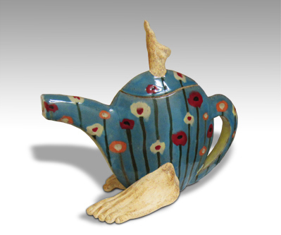 narrow teapot with human feet on either side at the base