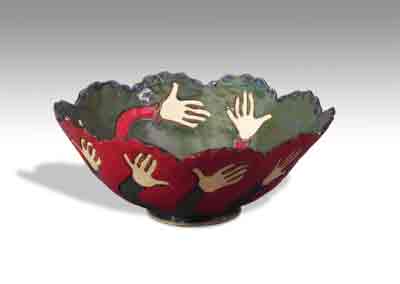 serving bowl decorated with looped arms and hands