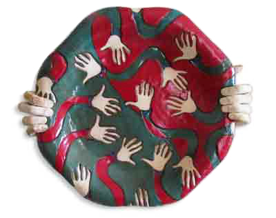 platter held by hands decorated with looped arms and hands