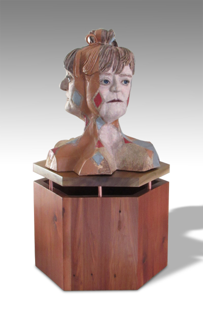 three-faced bust on wooden base