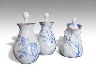 three small pots with withering form and blue and white roses