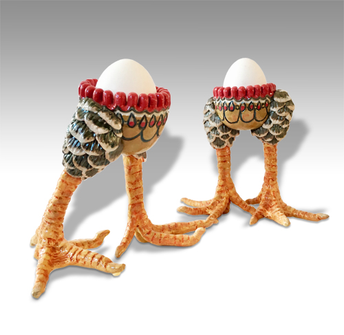 eggcups with chicken legs, one striding one standing straight