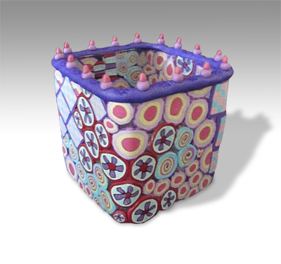 short square glassvase convered with pink and purple designs with tiny red-tipped turrets